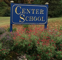 Center School Sign in a bed of flowers